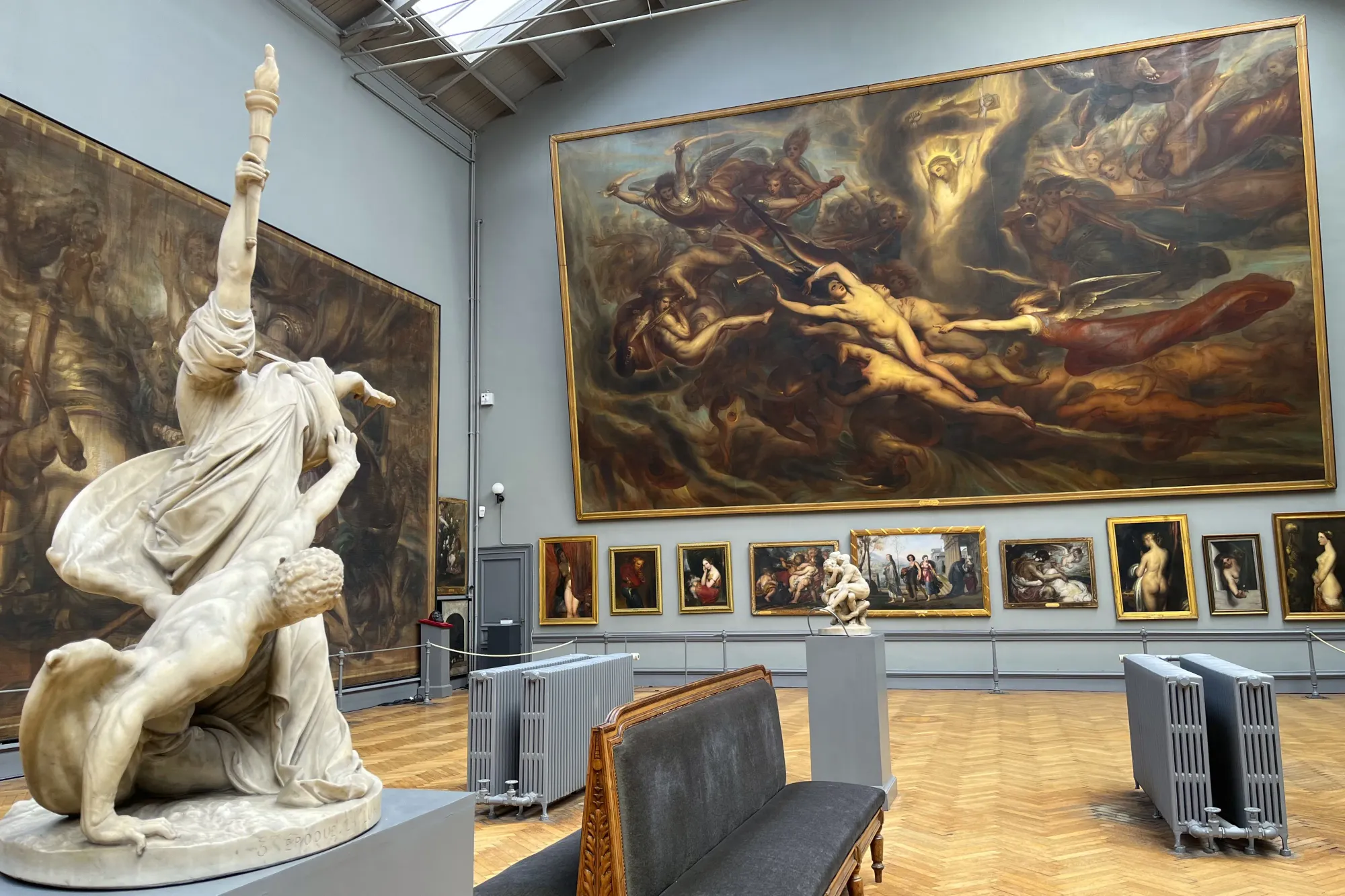 Large canvases with a smaller statue in the foreground
