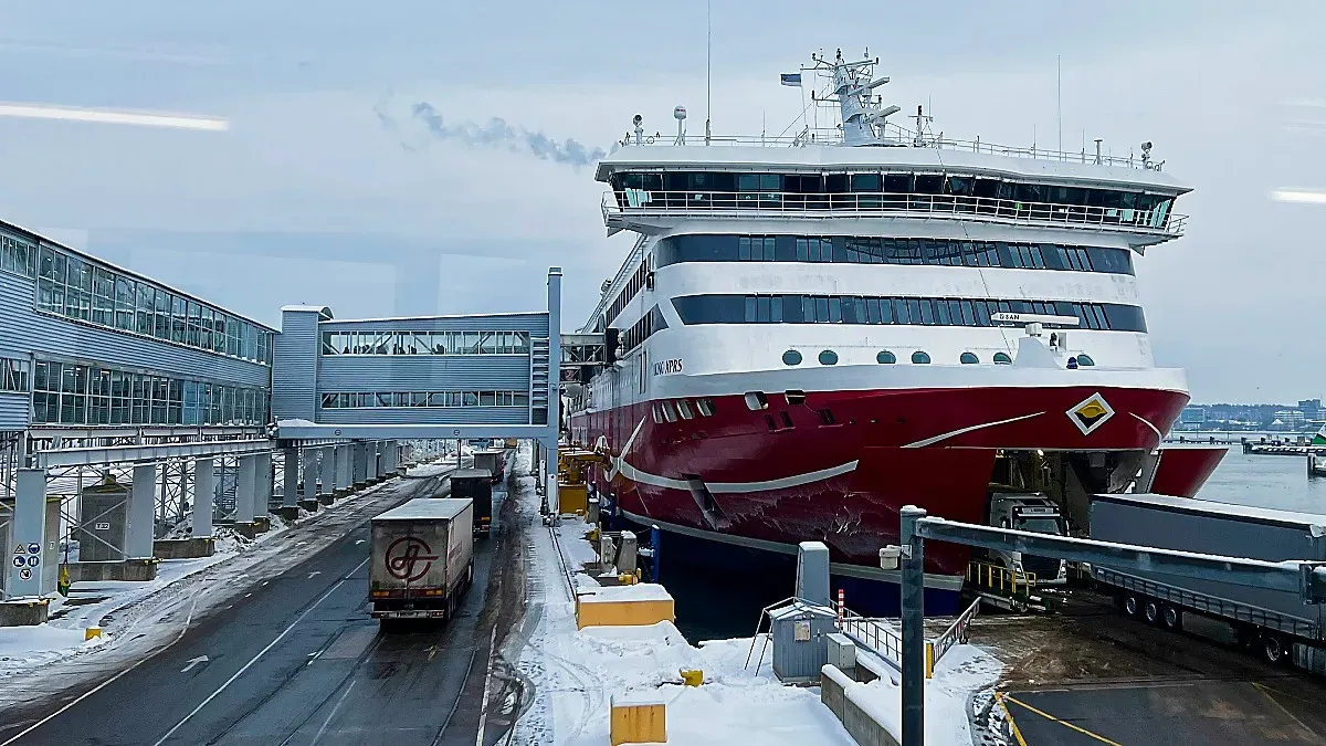 Red and white ferry with metal boarding ramp