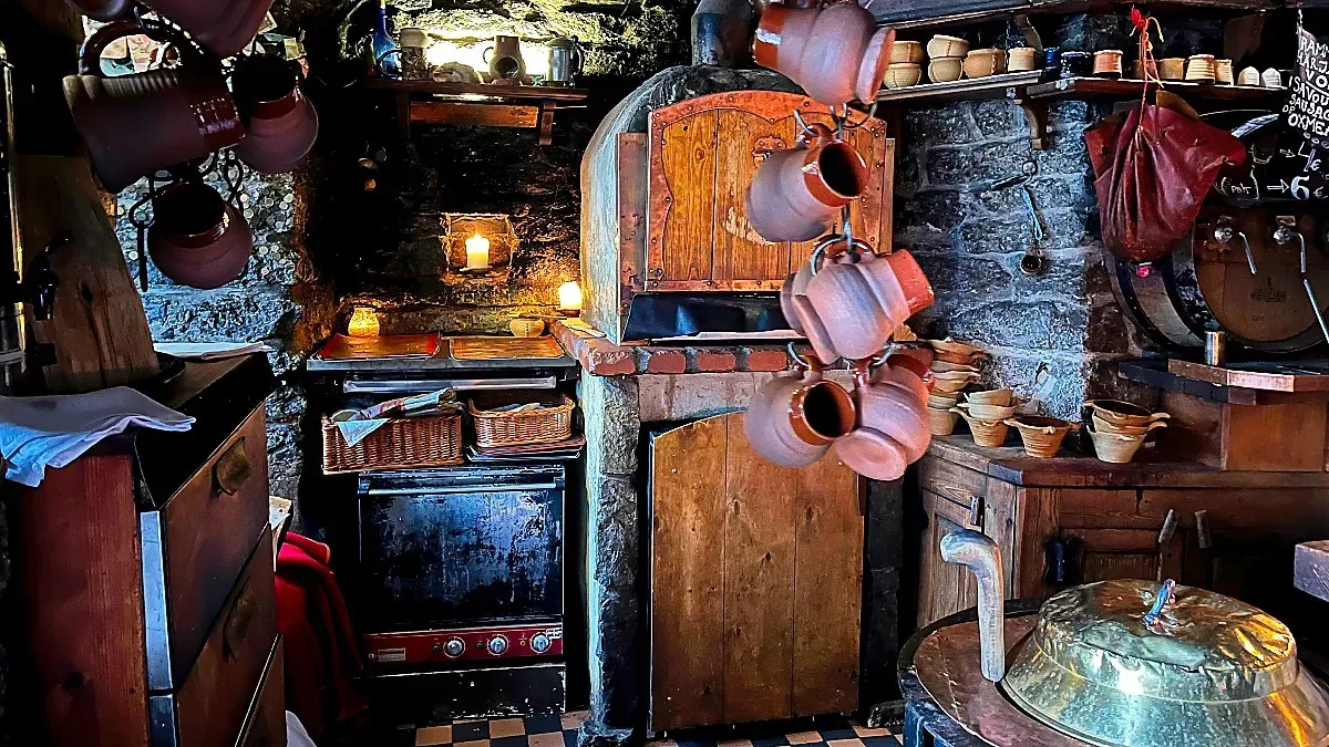 Stone tavern with wooden fire place and other clay and whicker bibs and bobs