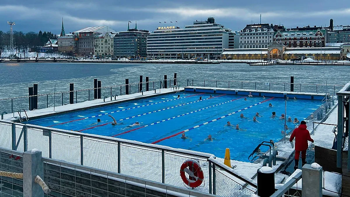 Outdoor pool set above an ice-covered bay