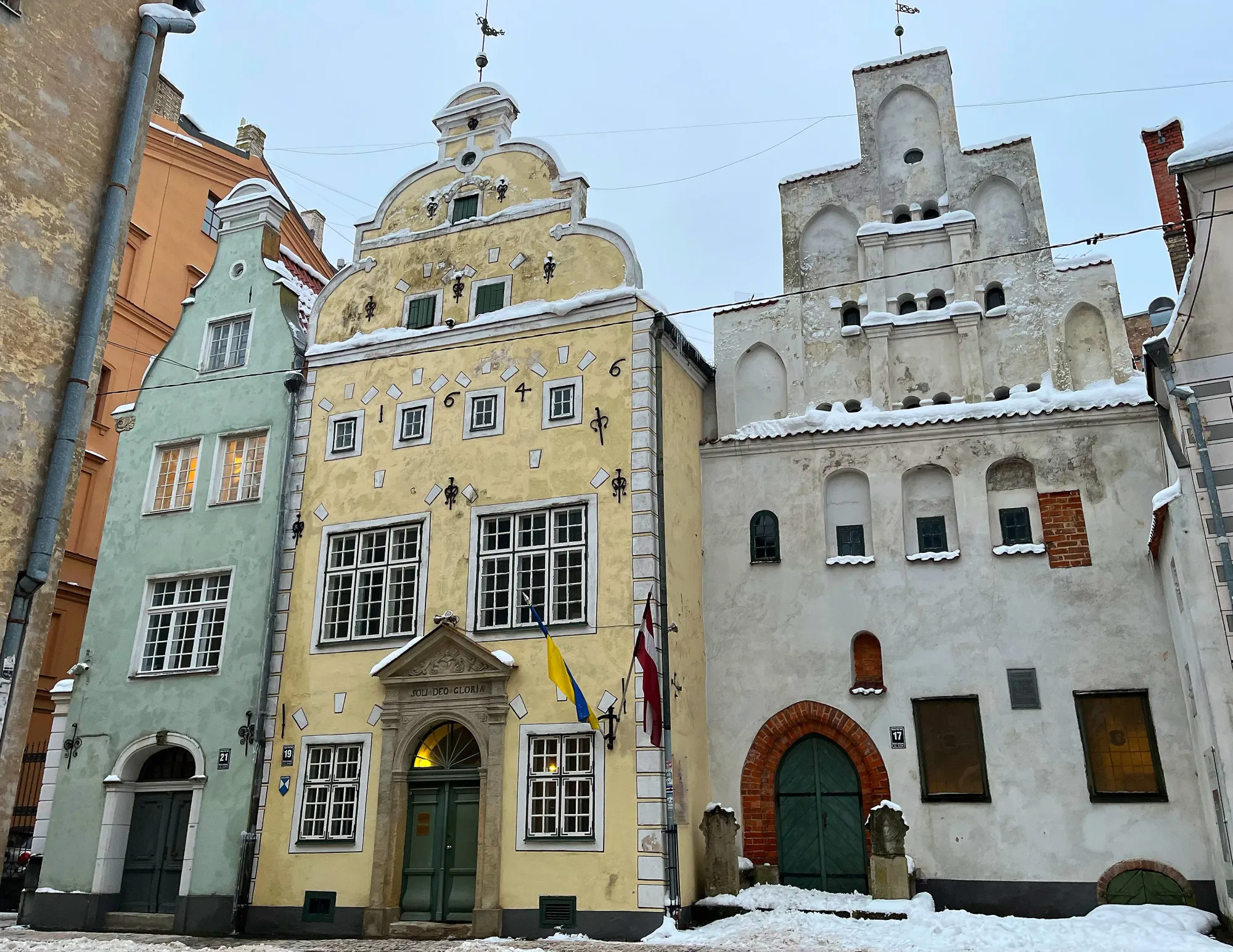 Old green, yellow, and white building faces