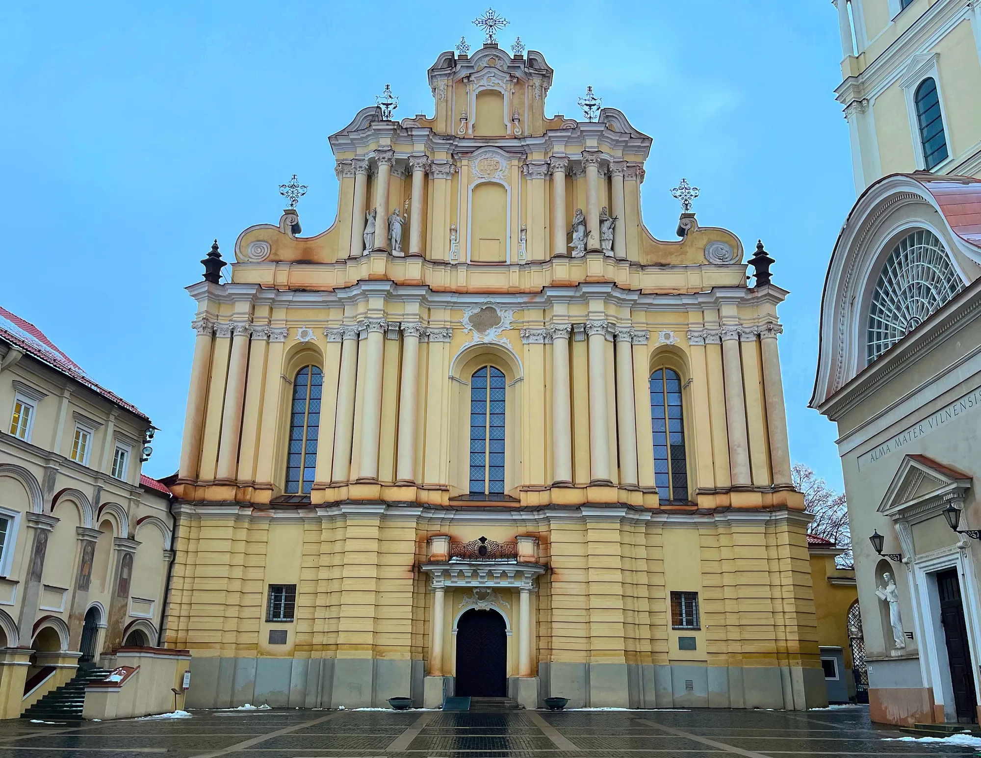 Yellow columned building with scroll details