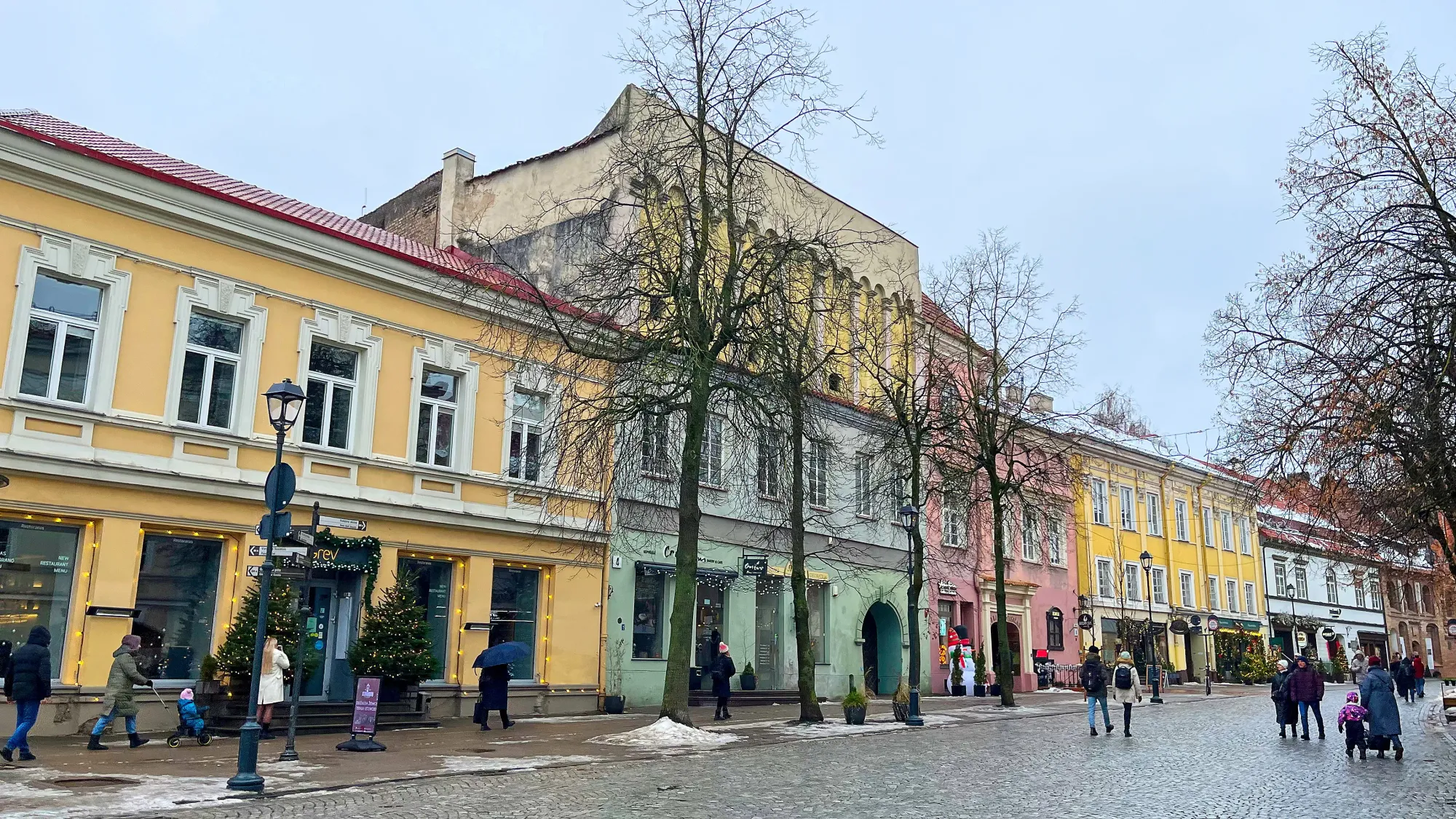 Yellow, green, pink pastel buildings with cobblestone streets