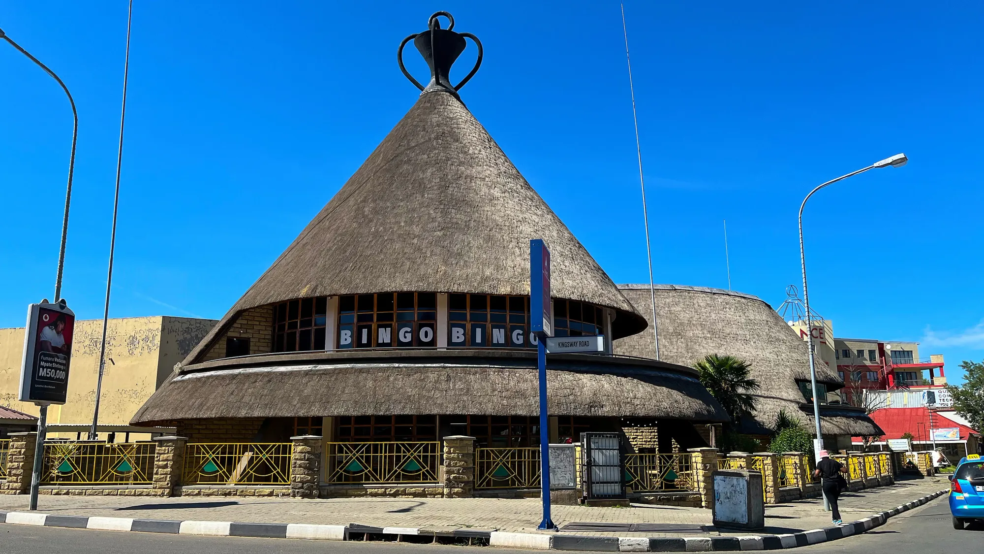 Grass roofed building in the conical shaped classic Basotho hat.