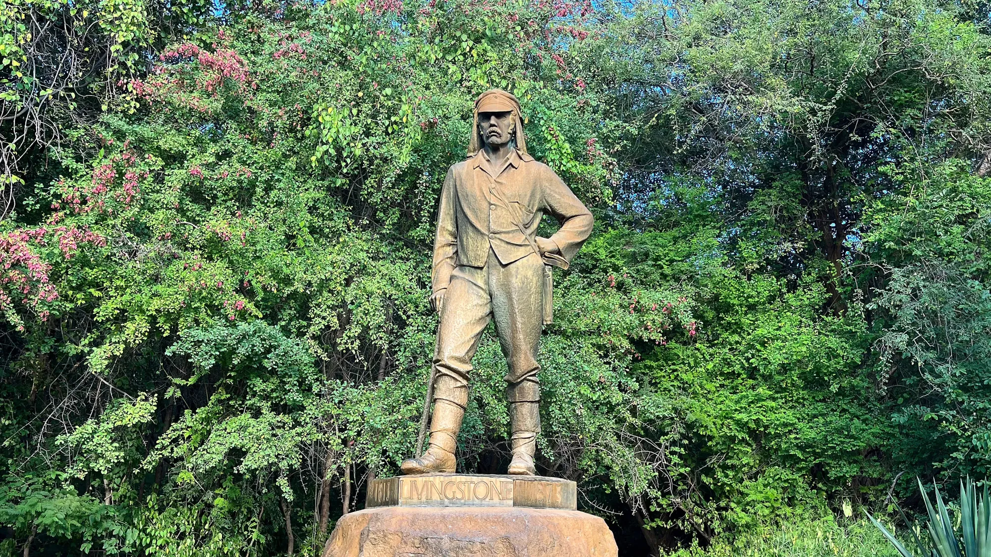 Statue of Mr. Livingstone before the jungle brush