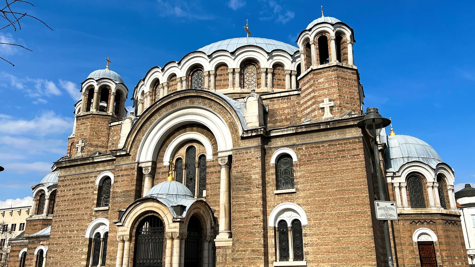 Brick structure with white-arches and metal domes.