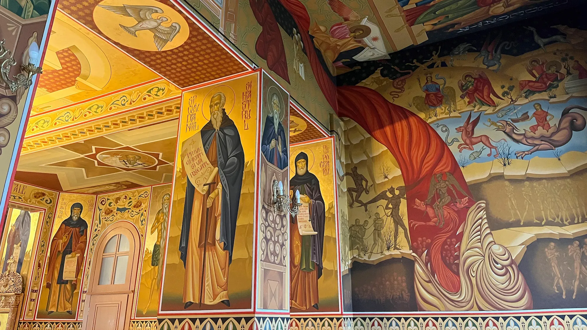 Vibrant wall paintings of orthodox saints and biblical stories on the walls