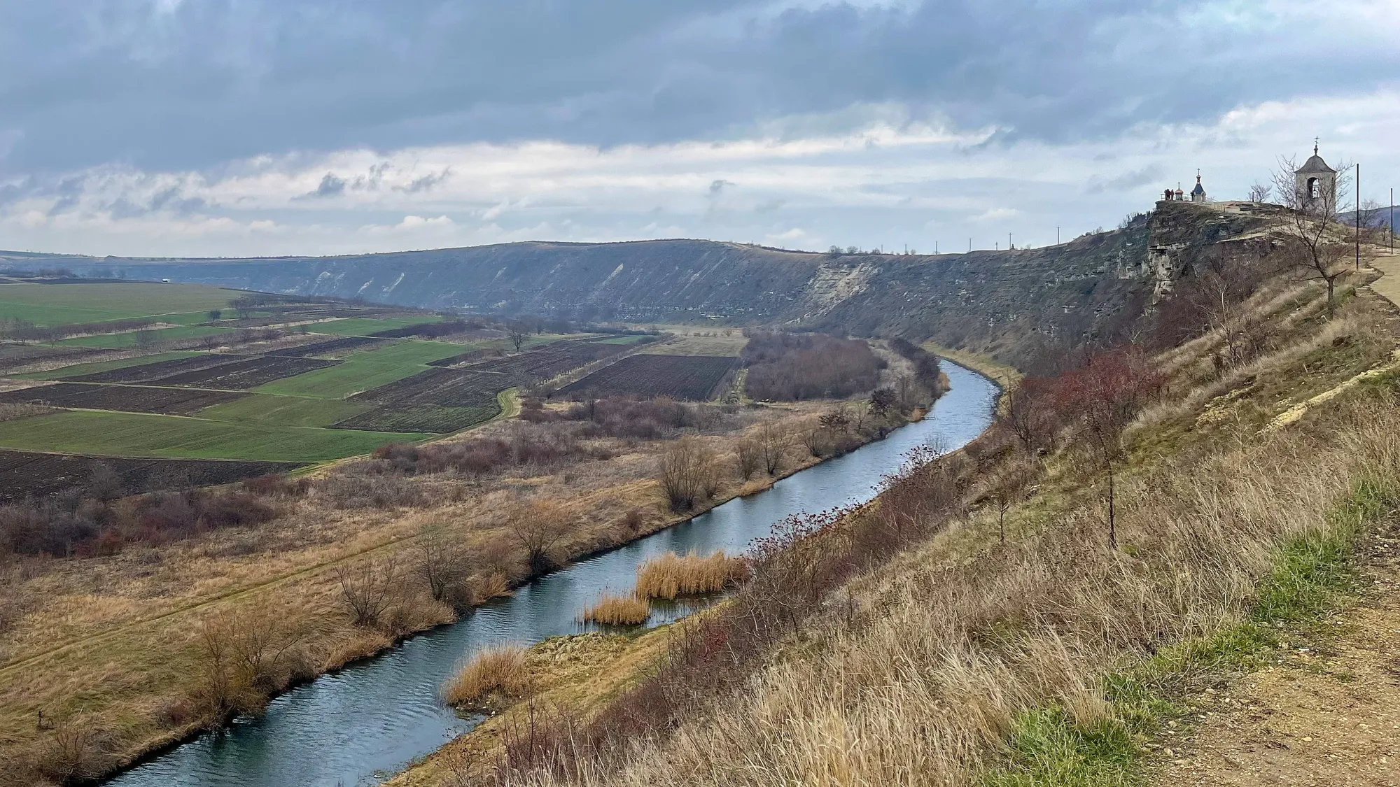 Viewpoint overlooking a sloping valley with a river running through it