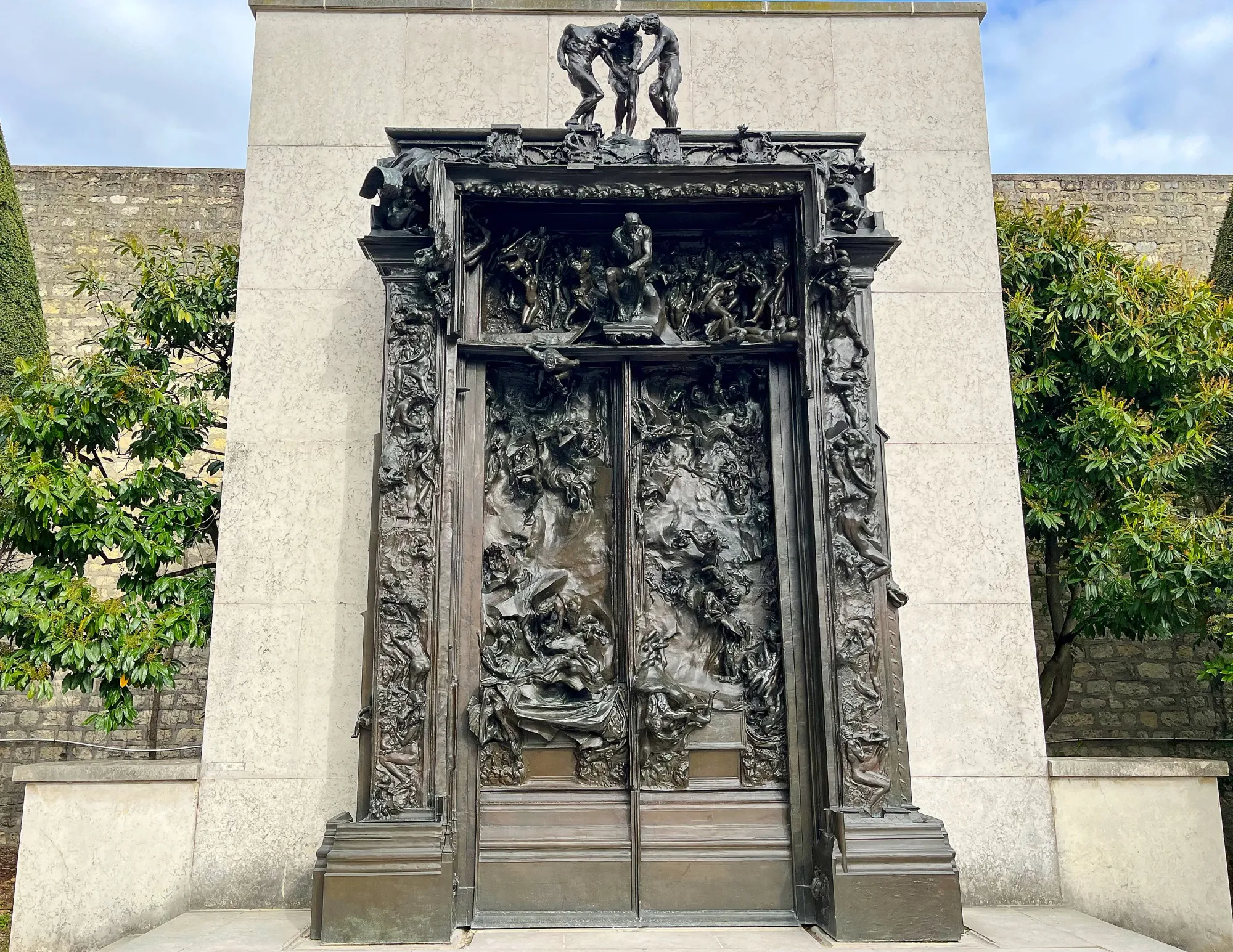 Bronze caste doors covered in statues of characters intertwined