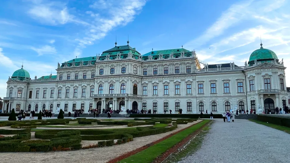 Large white palace with green rooftops