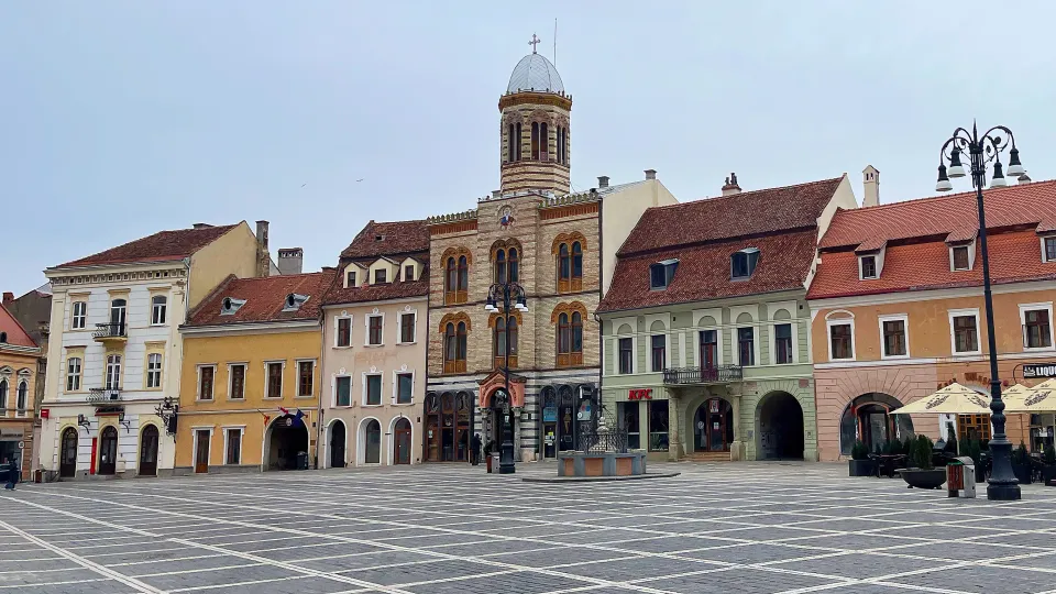 Checkered stone streets with a pastel colored row of shops