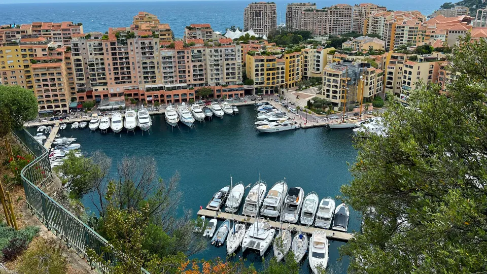 High altitude view looking down over the cityscape and harbor filled with white boats